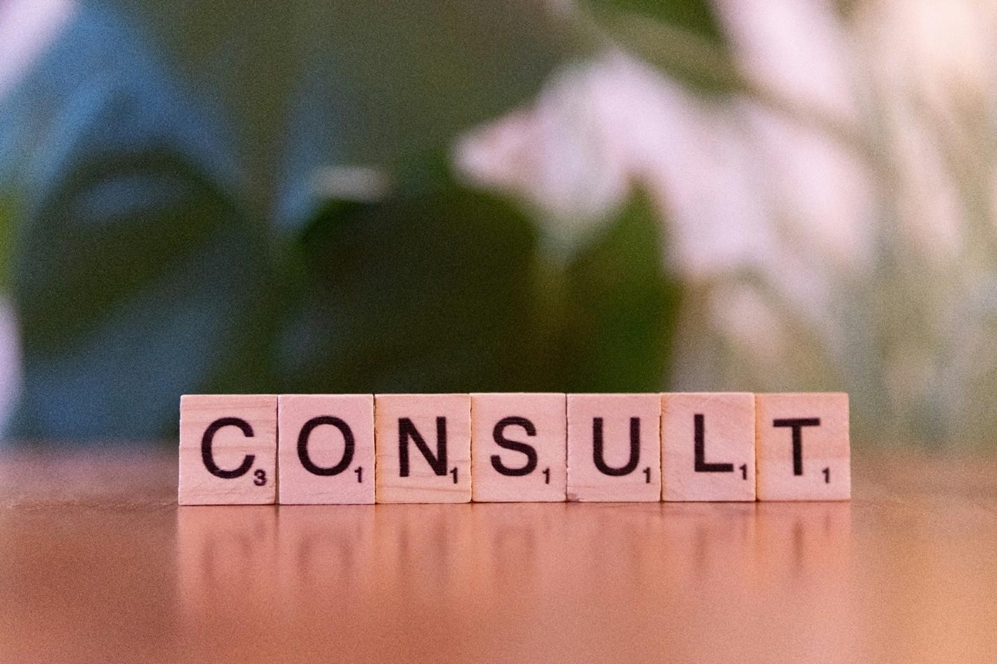 Consultant interacting with a digital “Consult” interface, representing Materials Metric’s regulatory strategy and compliance advisory services