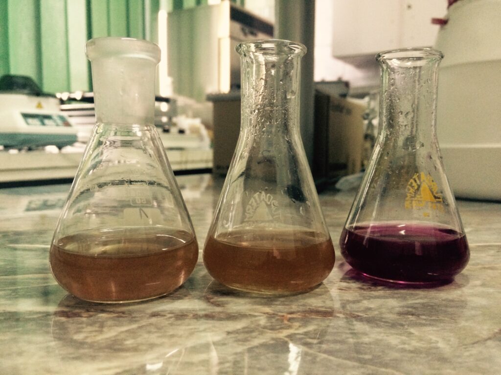 Laboratory setup performing a basic chemical assay in glassware