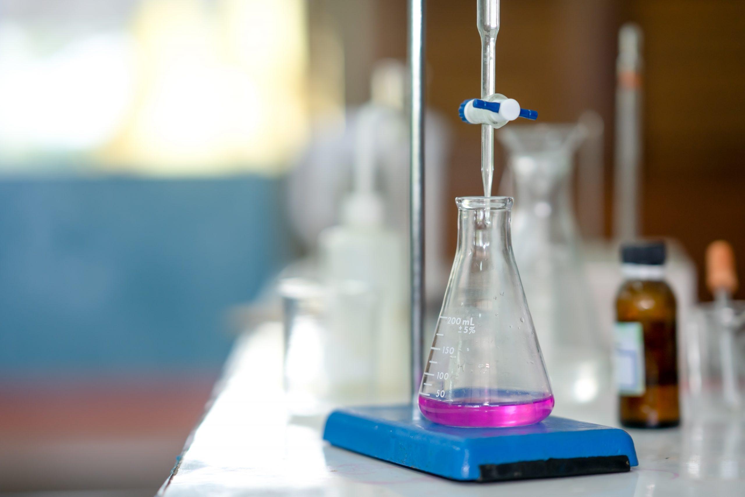 Chemical titration setup with burette and flask during quantitative analysis